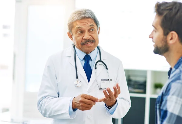 I want you to get plenty of exercise. a confident mature male doctor consulting with a patient inside of his office during the day