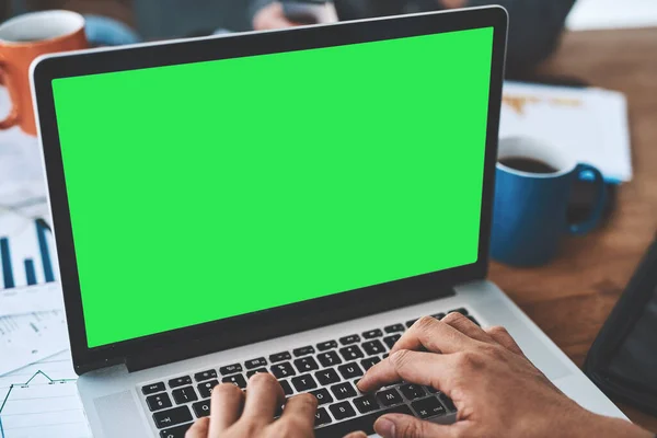 Green screen, copyspace and chromakey on a laptop of a business person typing an email, browsing the internet and planning. Closeup of employee designing a website and searching the web online.