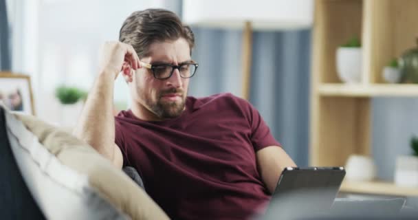 Stressed Man Bad Headache While Tablet Reading Watching Sitting Sofa — Stock video