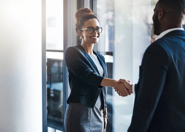 Im happy we could finally meet face to face. two businesspeople shaking hands in an office