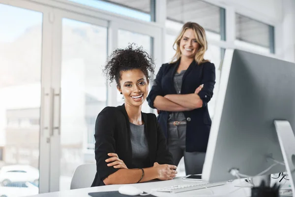 Its amazing how far passion can take you. Portrait of two businesswomen working together in an office