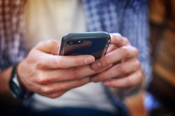 Every student cant go without their connections. Closeup shot of an unrecognizable university student using a cellphone at campus