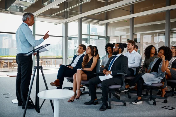 He has years of experience to draw from. Full length shot of a handsome mature businessman giving a presentation in the conference room