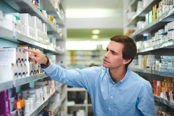 Knows What Works Him Handsome Young Man Looking Medication Pharmacy — Stock fotografie