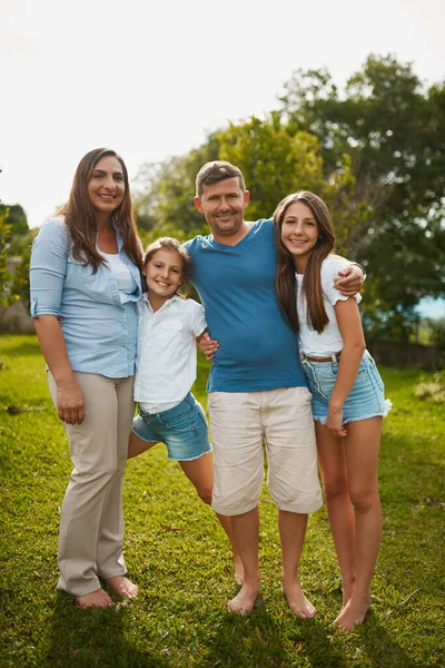 Theyre a picture book family. Full length portrait of a young family of four standing outside