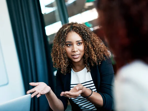Are you following. an attractive young businesswoman talking to a colleague during a meeting in the boardroom