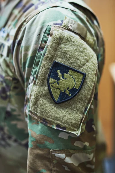 Soldiers wear their feelings on their sleeves. a soldier wearing camouflage fatigues with a patch attached to velcro on his sleeve