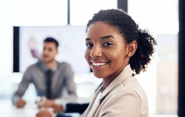 Every person is an important part of our team. Portrait of a confident young businesswoman having a meeting with colleagues in the boardroom of a modern office