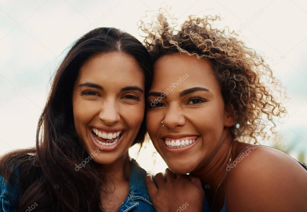 The right friendships bring nothing but happiness. Cropped portrait of two attractive young girlfriends smiling while standing together in a park