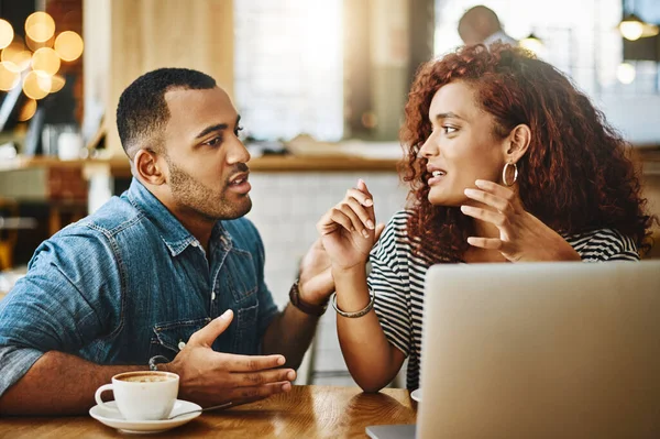 Open lines of communication. a young couple working on a laptop while sitting in a coffee shop