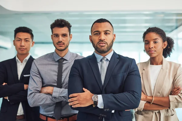 They are the best candidates for the job. Portrait of a group of confident young businesspeople standing with their arms folded inside of the office at work during the day