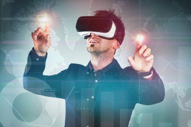 Have the business world at your fingertips. Studio shot of a handsome young businessman using a vr headset against a digitally imposed background