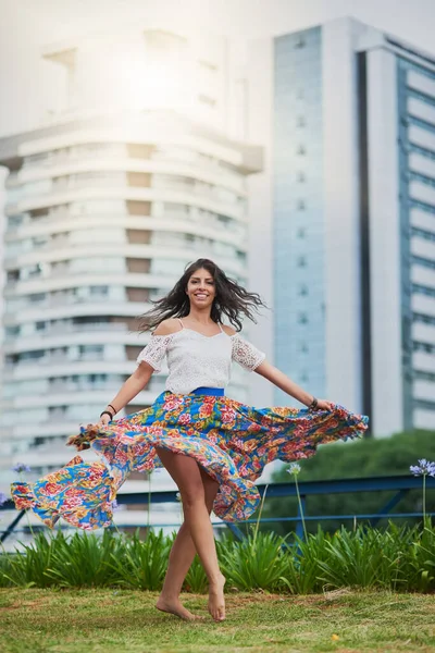 The city ignites a spark in my soul. Portrait of an attractive young woman dancing in the city