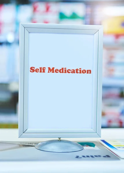 The self medication counter makes it easier for customers. a sign with the words self medication written on it at a pharmacy