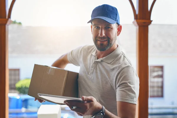 Told you were fast with our deliveries. Portrait of a courier making a home delivery