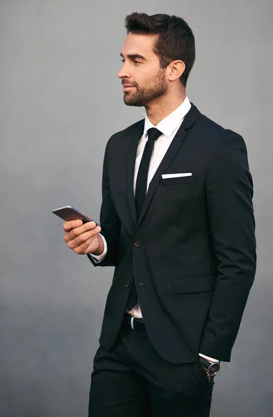 Hes Easily Reachable Studio Shot Handsome Young Businessman Using Cellphone — Foto de Stock