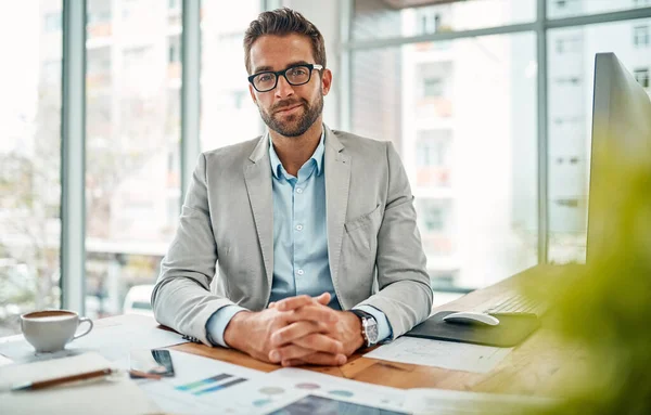 No matter how successful you are, always aim higher. Portrait of a handsome young businessman sitting in an office