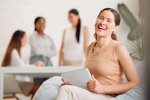 Businesswoman, team leader or manager on a tablet working at a female only company or women empowerment workplace with colleagues in background. Corporate professional with business success portrait.