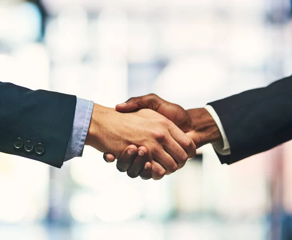 Its a done deal. Closeup shot of two unrecognizable businessmen shaking hands in an office