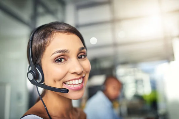 Cant wait to answer your call and answer any queries. a young attractive female customer support agent working in the office