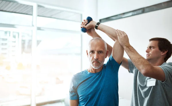 Technique Key Young Male Physiotherapist Helping Client Stretching Exercises His — Zdjęcie stockowe