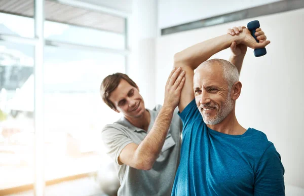 Youre Doing Really Well Young Male Physiotherapist Helping Client Stretching — Stockfoto