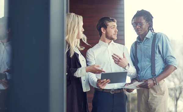 Young Strategists Three Young Businesspeople Using Tablet While Standing Office —  Fotos de Stock