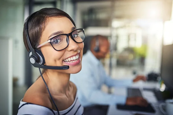 The most friendly customer service agent in the office. a young attractive female customer support agent working in the office