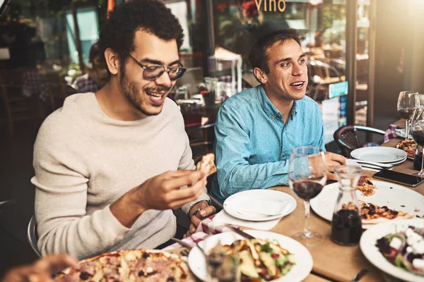 Shall Start Two Cheerful Young Men Seated Table Eating Pizza — Fotografia de Stock