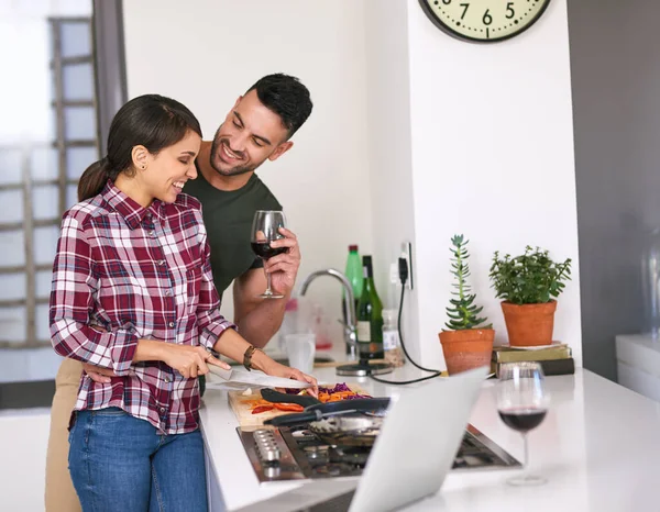 The best food is made with love. a young attractive couple cooking together in the kitchen at home