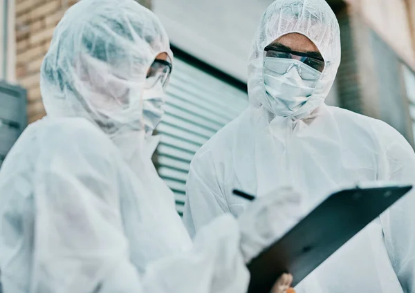 Healthcare Workers Wearing Protective Hazmat Suits Writing Medical Report Covid — Zdjęcie stockowe