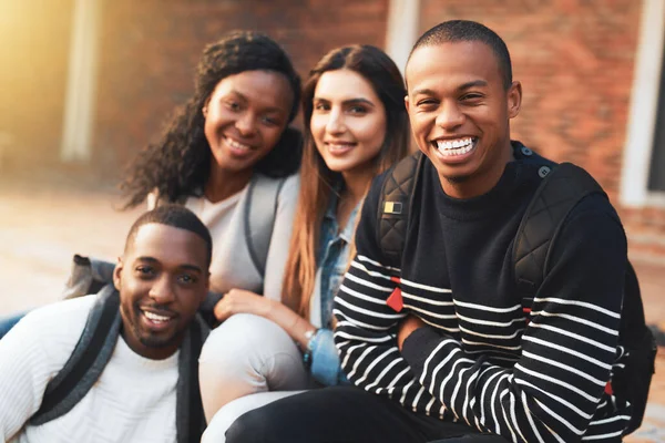 Whats the college experience without good friends. Portrait of a group of students relaxing together during a break on campus