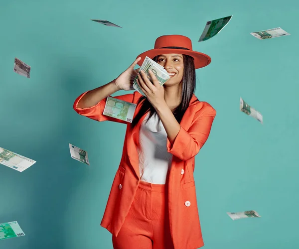 Cash, fashion and rich lady throwing money and spending away smiling as she shows off her wealth after shopping. Trendy, happy and winning luxury woman with 100 dollar bills in the air at the casino