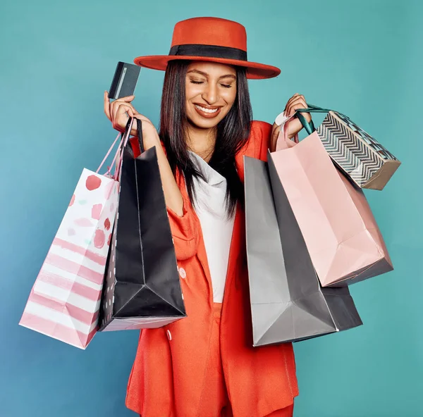 Credit card, fashionable and trendy woman shopping for new style and buying modern stylish clothes with her money. Edgy, beautiful and happy shopper smiling and enjoying her fun clothing spree.