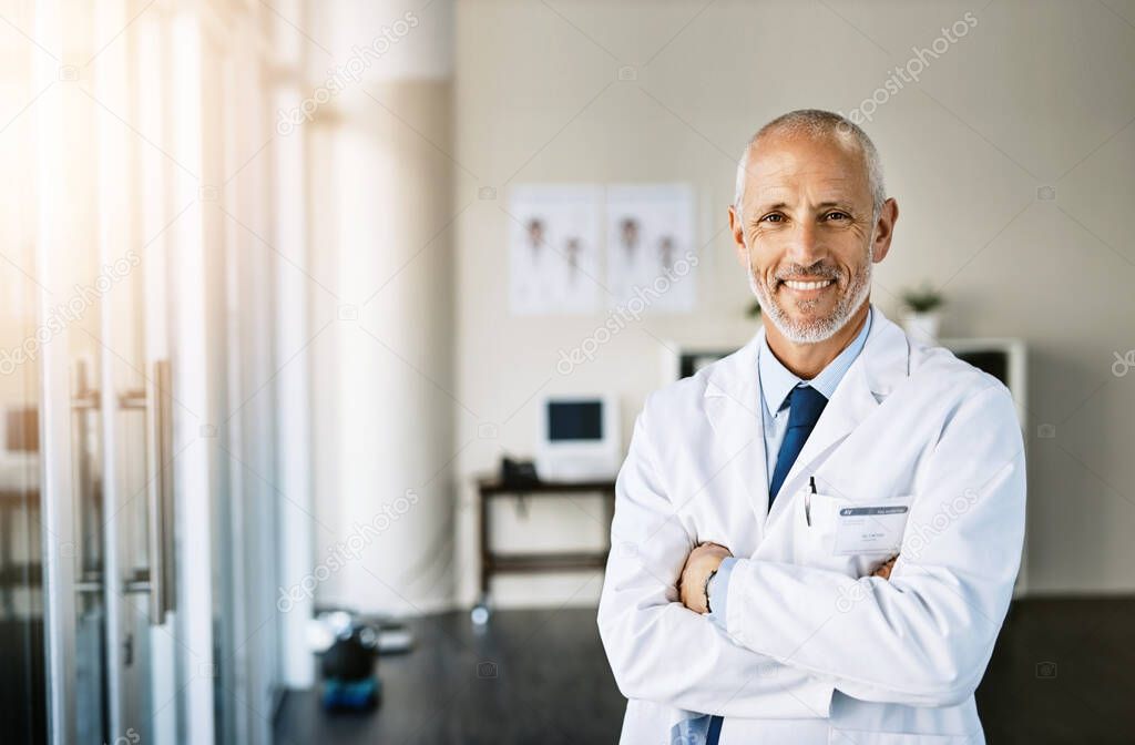 Call on me to care for your health. Portrait of a mature doctor standing in a hospital