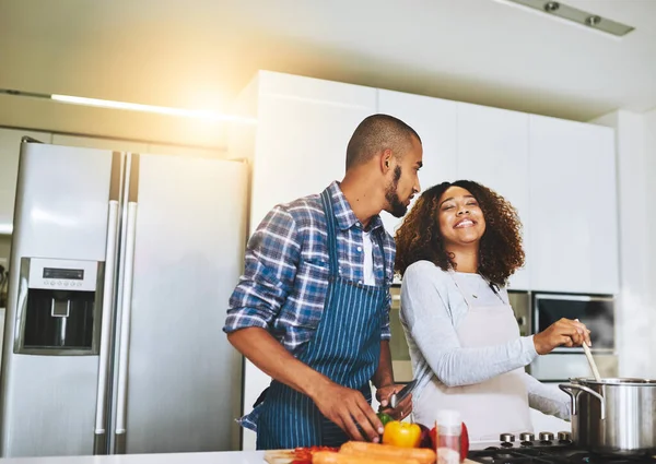 Food brought us together, love kept us together. a young couple cooking together at home