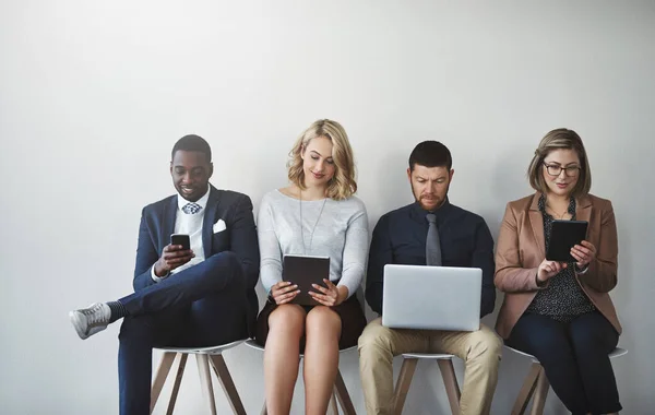 Using Technology Keep Busy Studio Shot Businesspeople Waiting Line White — Stockfoto