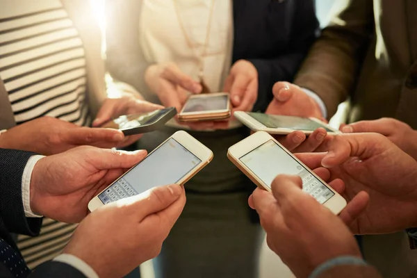 Theyre Connected Group Businesspeople Using Cellphones While Standing Huddle — Stockfoto
