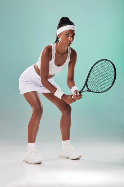 Sports motivation, training and young woman with focus ready to start with tennis. Portrait of an Indian fitness sport coach ready to play and exercise feeling the competition energy and power.