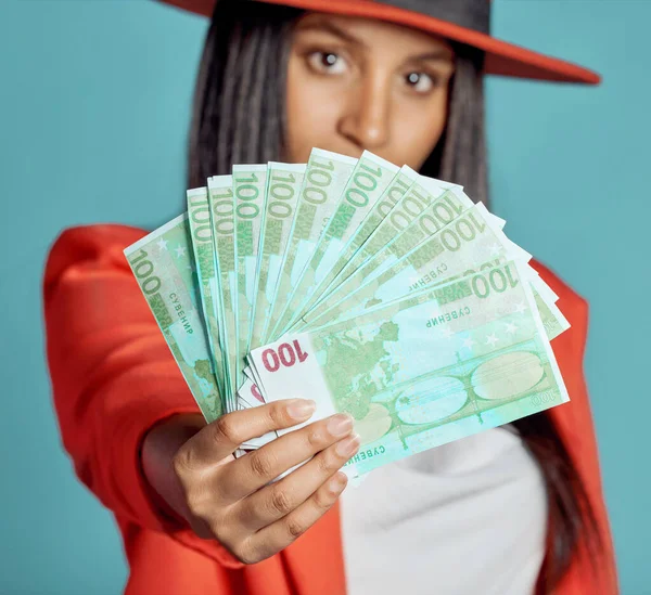 Rich, wealthy and stylish woman showing her money and success in fashion posing over copy space. Fashionable female advertising a cash prize or lottery win from a competition.