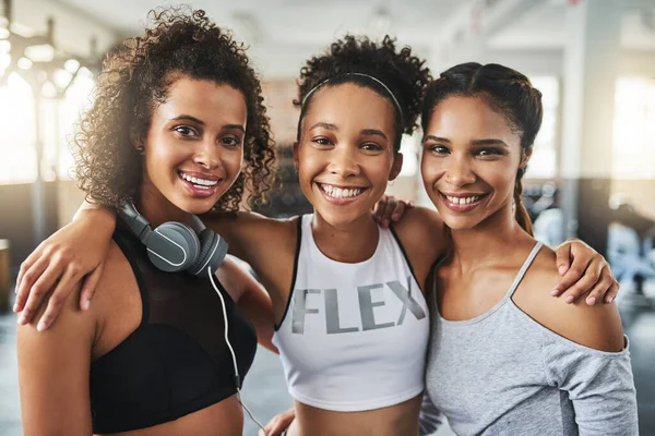 Good friends keep you in good health. a group of happy young women enjoying their time together at the gym