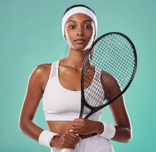 Woman sport tennis player and athlete feeling strong with female empowerment and motivation. Portrait of a fit, serious and young athletic indian lady looking motivated, determined and confident.