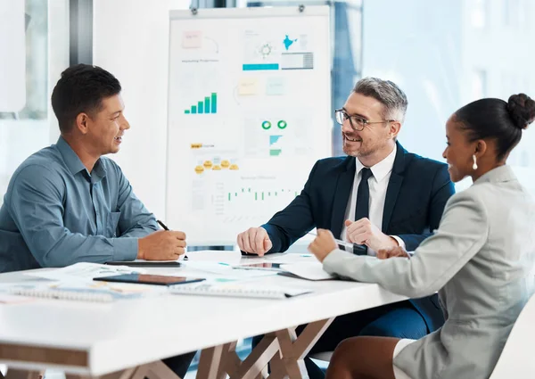 Business meeting, planning and teamwork while sharing idea for financial growth and innovation by marketing team discussing graphs and data in boardroom. Diverse colleagues sharing vision and mission.