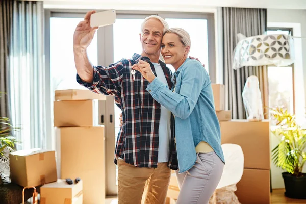 Brand new memories for a brand new home. a happy mature couple taking a selfie on moving day