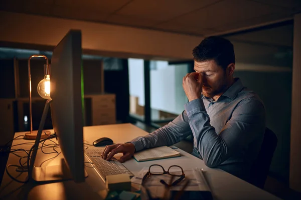 Wish these deadlines would just disappear. a young businessman looking stressed out while working in an office