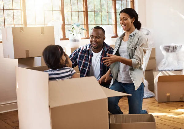 Its a fun time to play hide and seek. a family having fun while moving house