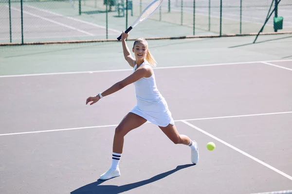 Fitness, balance and sport with athletic tennis player playing competitive match at a tennis court. Female athlete practicing her aim during a game. Lady enjoying active hobby shes passionate about.