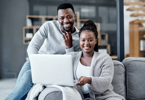 Happy couple browsing on a laptop, banking online and applying for a home loan, mortgage bond or insurance. Portrait of a black man and woman managing finances and studying with online education.