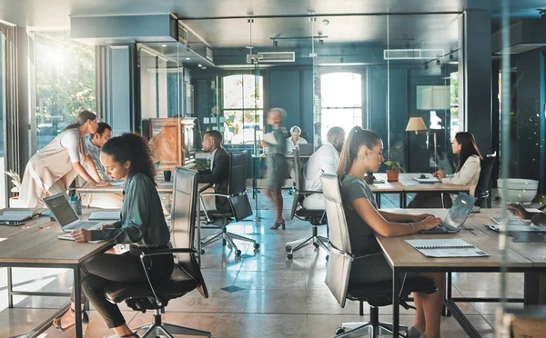 Corporate business people working in busy marketing office space, planning strategy in books and reading email on laptop at work. Businessman, businesswoman and workers at startup advertising company.