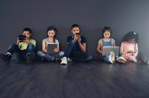 Learning Technology Literate Studio Shot Kids Sitting Floor Using Wireless —  Fotos de Stock